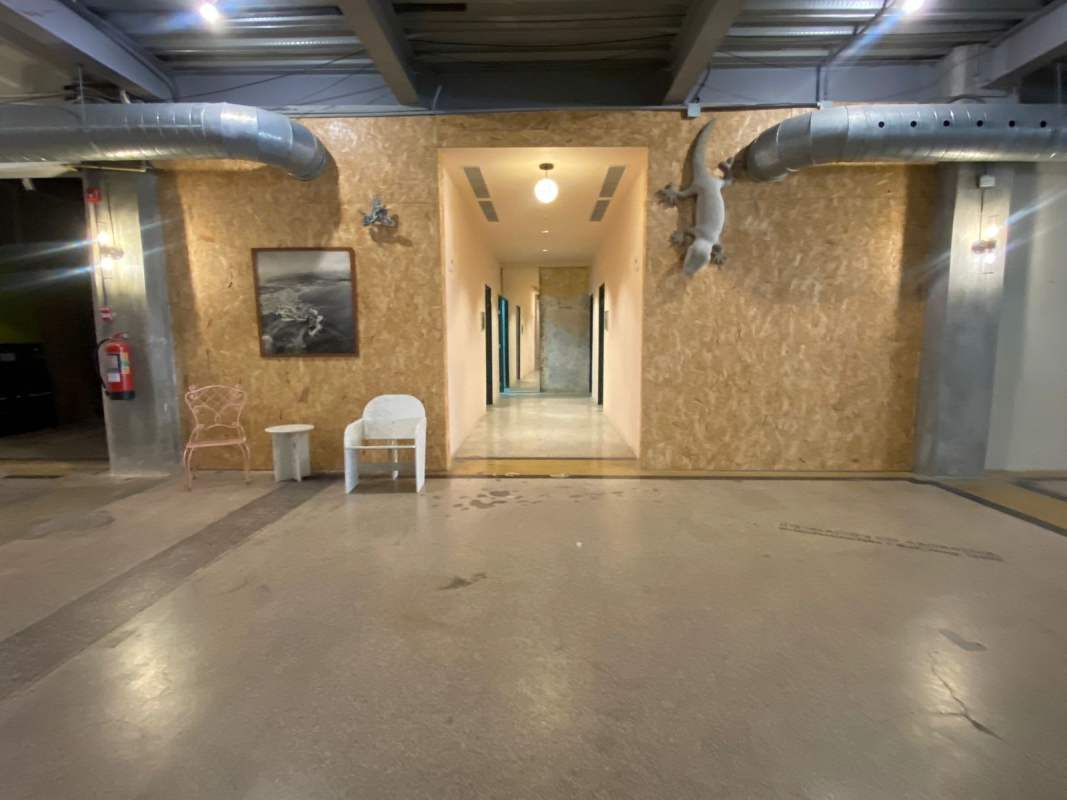 Industrial style hallway with exposed ducts plywood panel walls Edificio Heurtematte Casco Viejo Panama