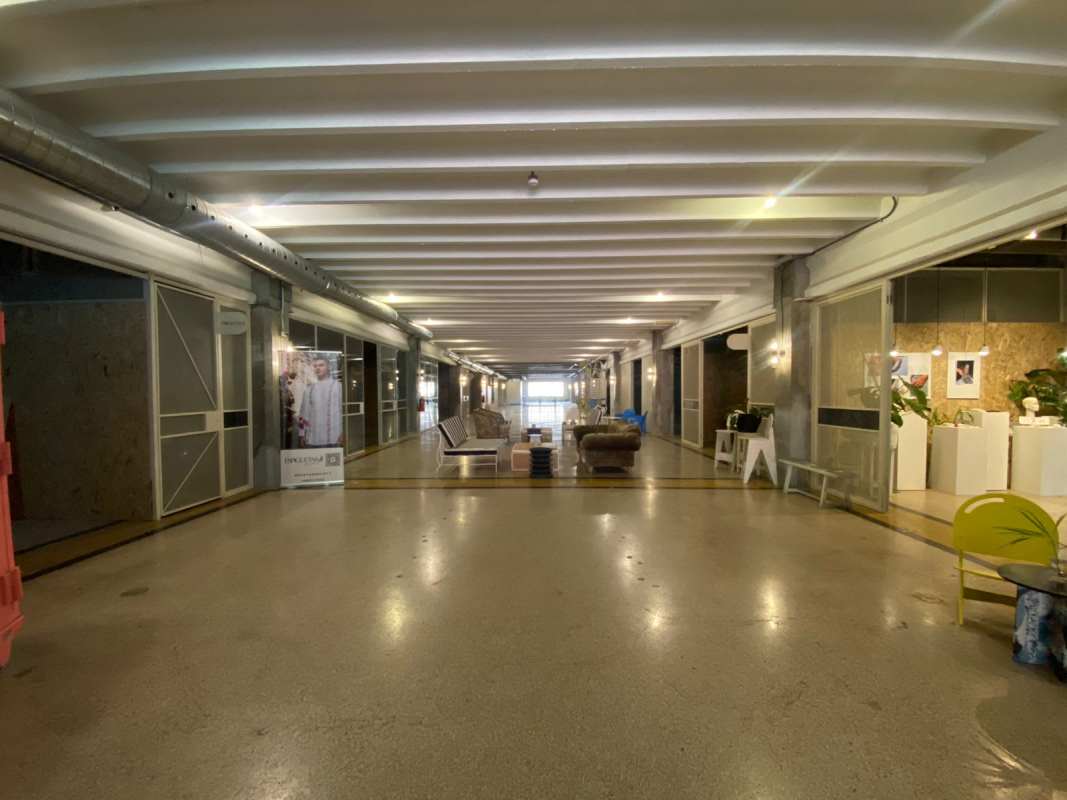 Wide commercial corridor with storefronts and polished concrete floor in Edificio Heurtematte Casco Viejo Panama