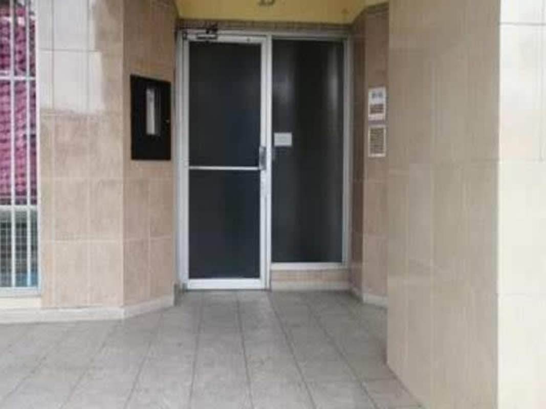 Entrance with glass door, metal gate and tiles at PH Plaza Bella Vista Bella Vista Panama