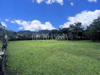Open grassy lot with wooden fence, panoramic mountain backdrop - El Valle Coclé Panama