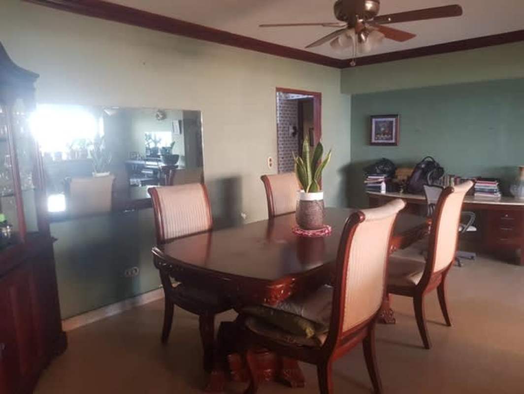 Spacious bedroom with wardrobes blue accent wall PH Anayansi Bella Vista Panama