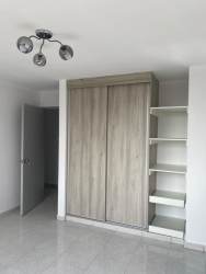 Modern bedroom with built-in sliding wardrobe, tile floor, natural light in PH Dorado Tower El Dorado Panama