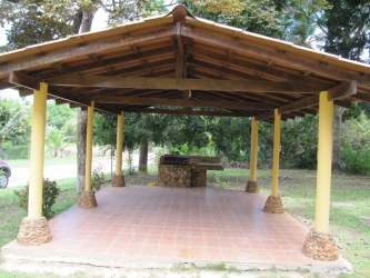 Rustic kitchen with wood beams, breakfast bar, white cabinets in Coronado Panama