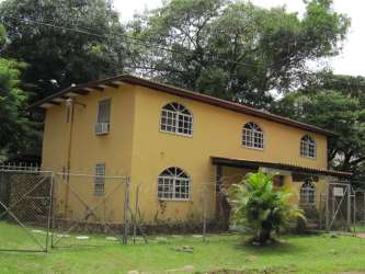 Bedroom with wood floors and red curtains at Brisas del Coronado Coronado Panama