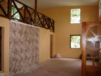 Exterior yellow two-story home garden yard Brisas del Coronado Panama