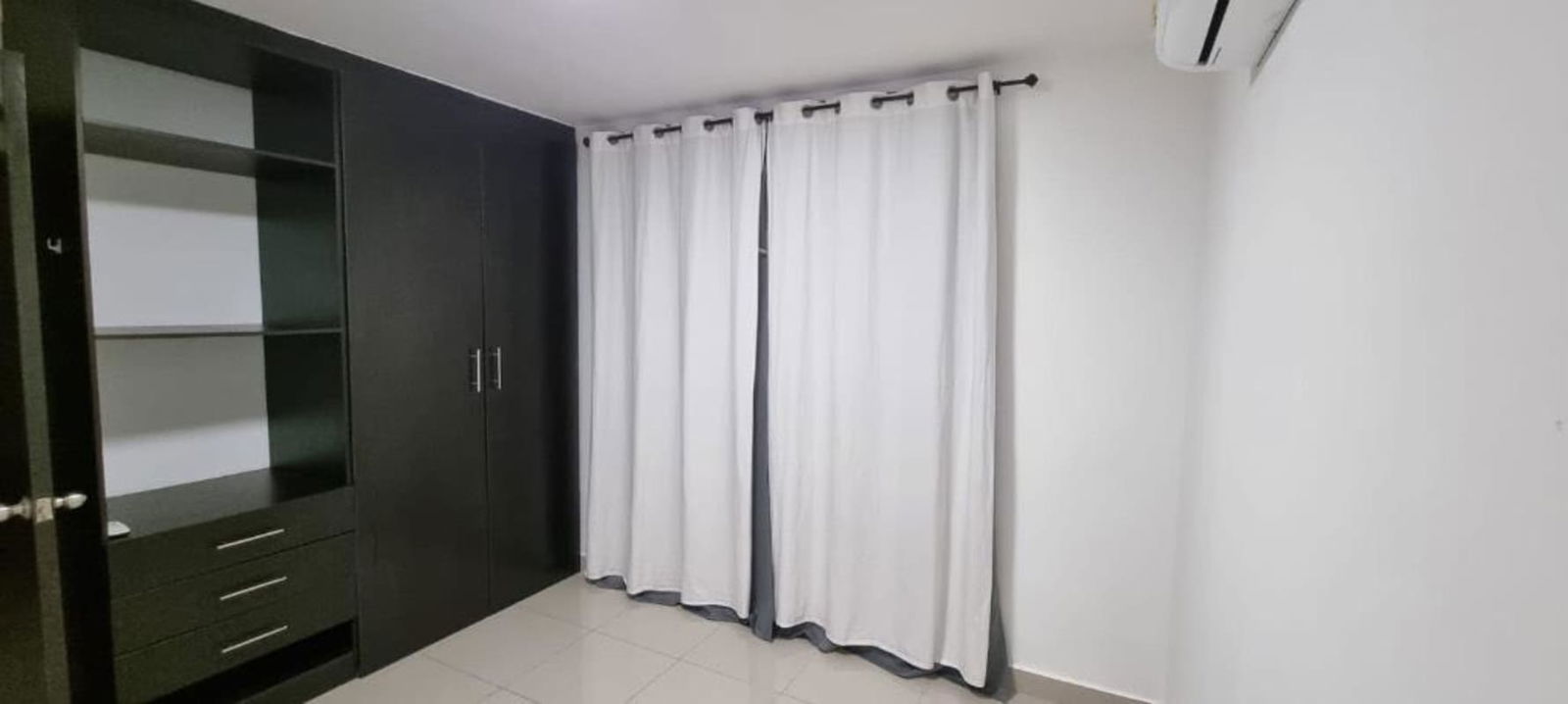 Modern apartment kitchen with granite countertop, double sink, and appliances Panama