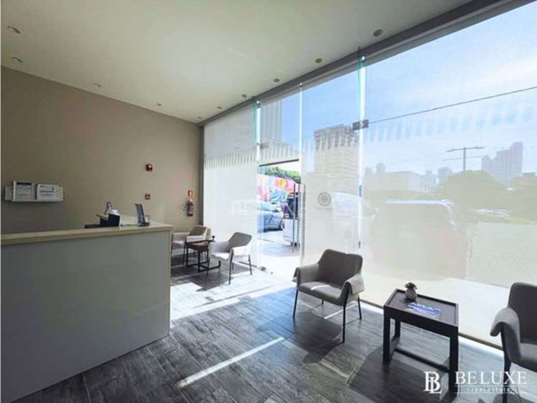 Reception with display shelves, TV and seating for commercial rental in San Francisco, Panama