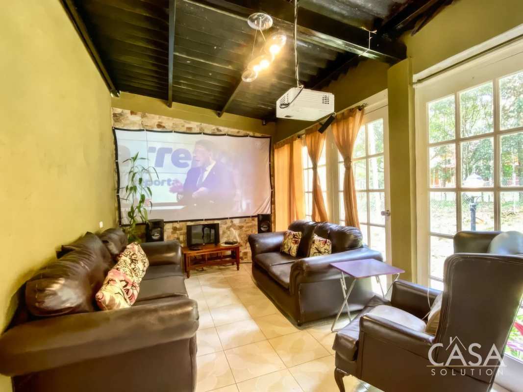 Covered wraparound balcony overlooking trees and creek in Altos de Cerro Azul housing community