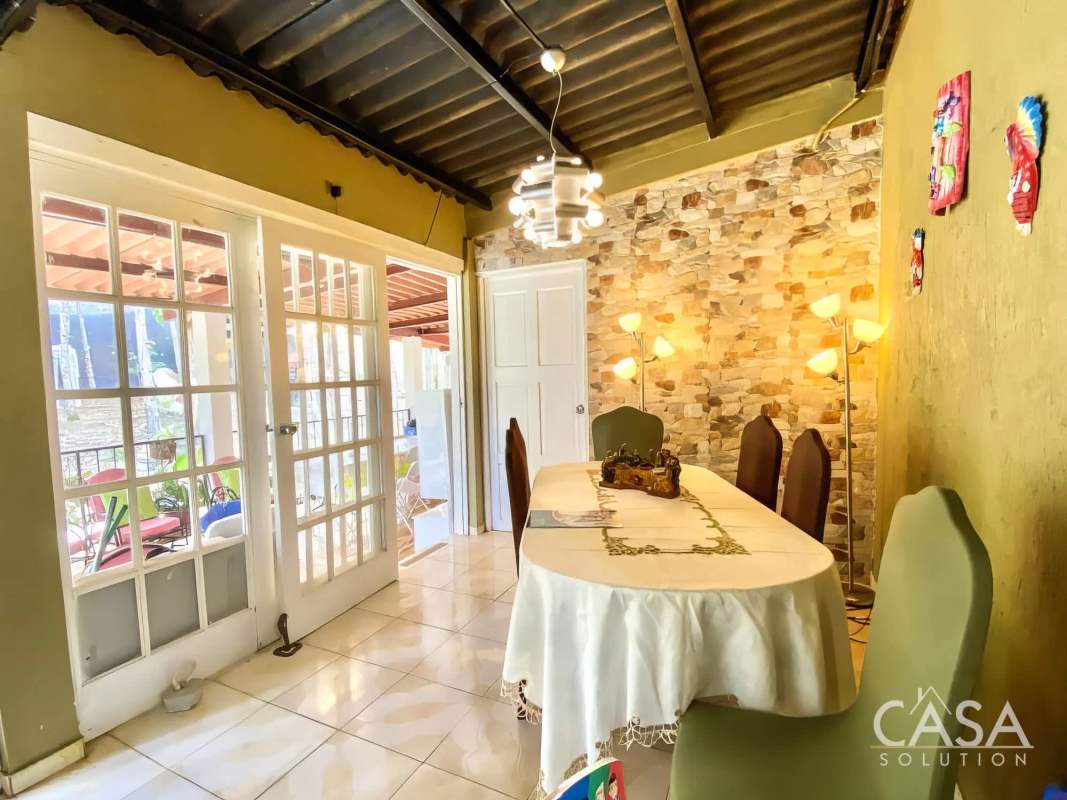 Rustic dining room with stone accent, French doors and exposed beams Cerro Azul Panama