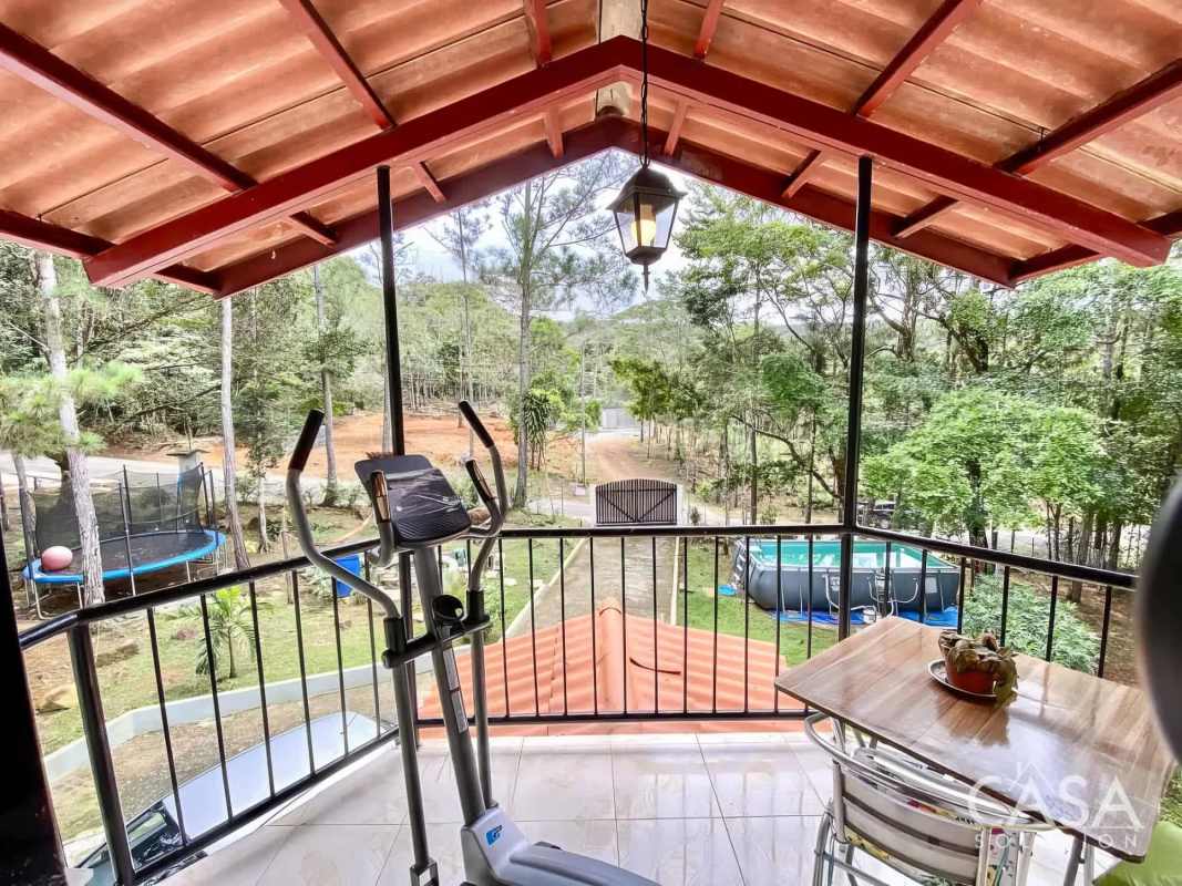Covered balcony with exercise equipment, seating and countryside views Cerro Azul Panama