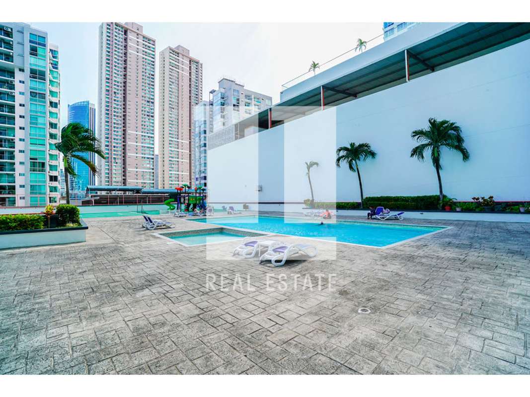 Outdoor pool area sun loungers palm trees PH Sol del Este Costa del Este Panama