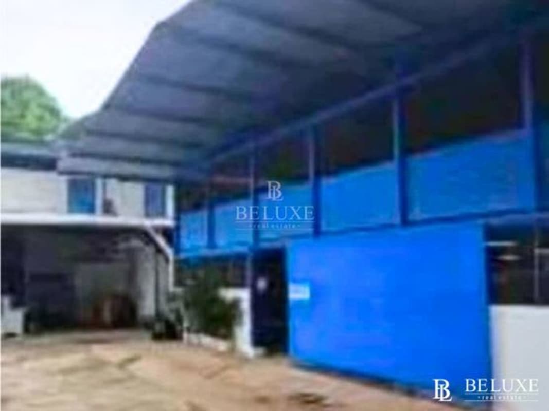 Spacious interior warehouse with metal shelving units concrete floor and open storage areas in Pueblo Nuevo Panama