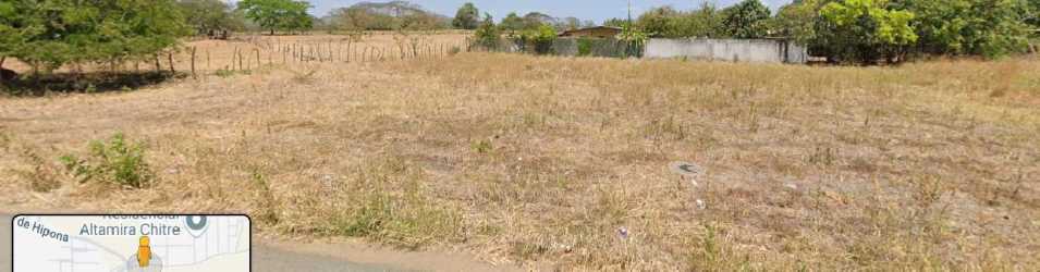 Vacant undeveloped land beside rural structures and trees in Chitré Panama