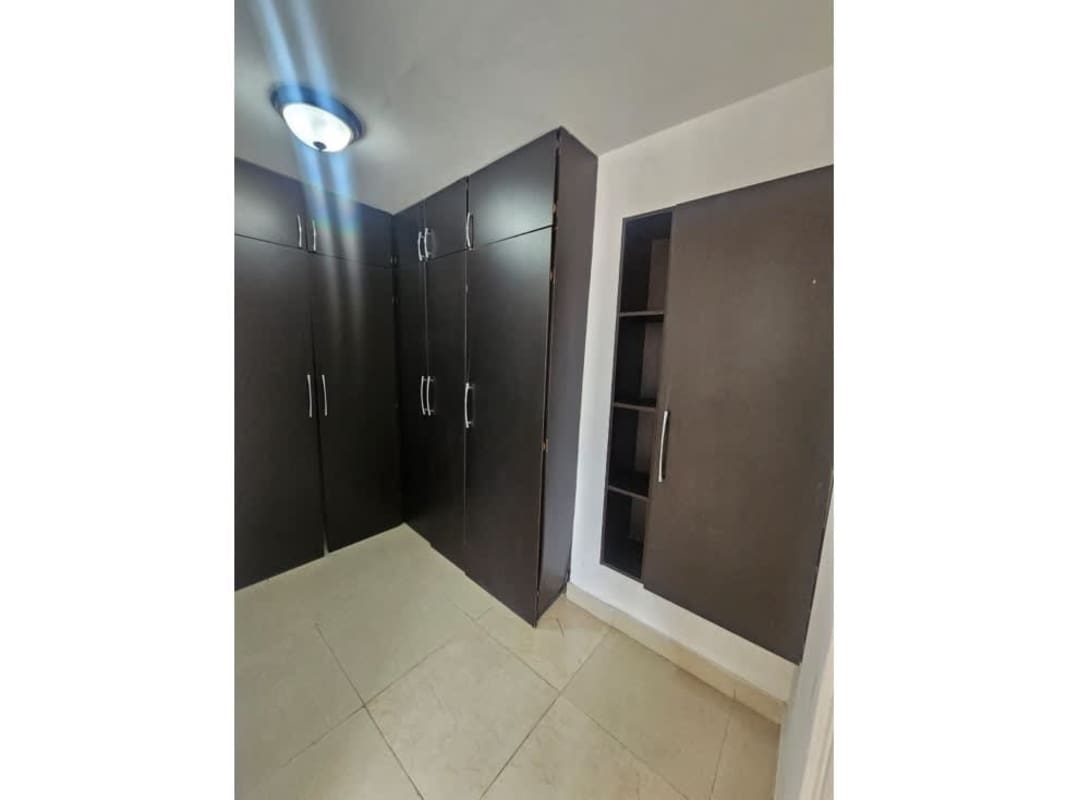 Bathroom with enclosed shower, vanity, tile walls, clean design in Dos Mares Tower Panama