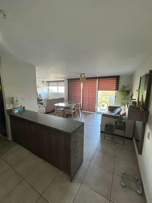 Bright open-plan living dining area with balcony access ceramic tile floors PH Brisas del Golf San Miguelito Panama