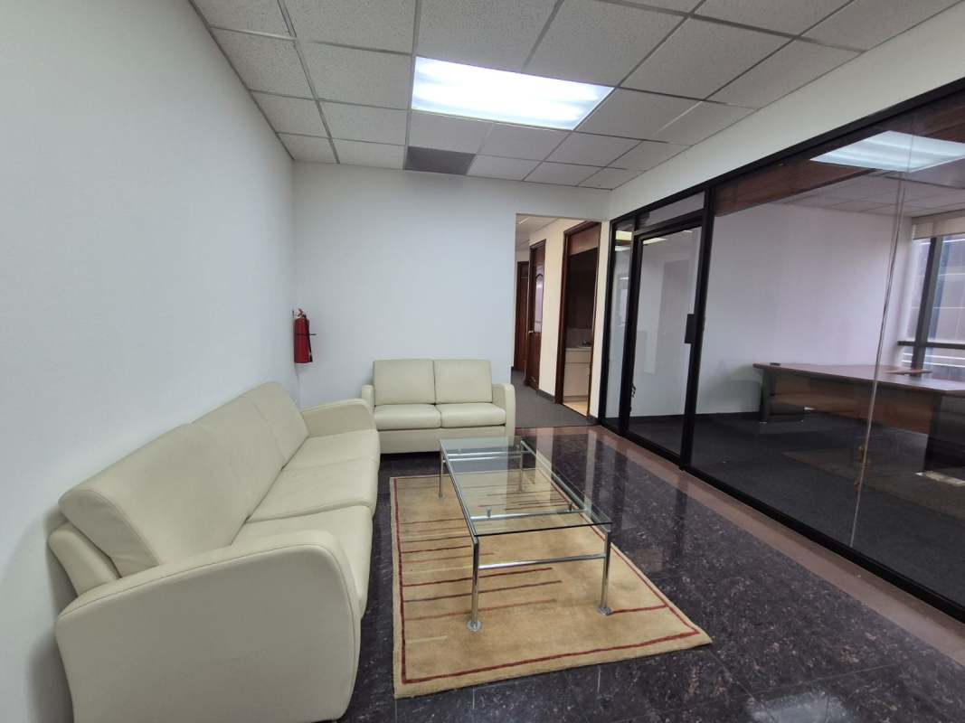 Modern office entrance area with sofas, marble flooring, glass partitions in Banco General Building Calle 50 Panama