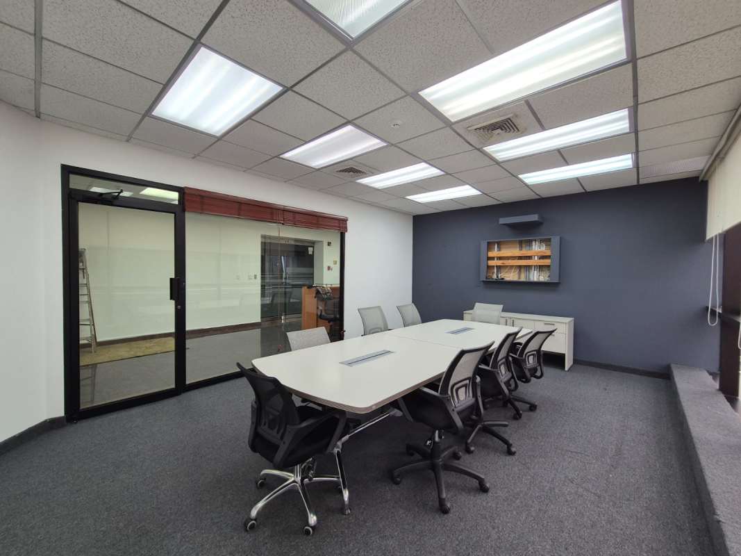 Open-plan modern office with cubicles, large windows overlooking Panama City skyline at Banco General Tower Calle 50