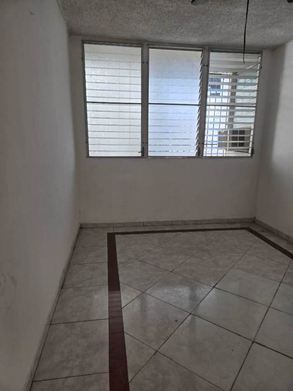 Bedroom with window, built-in closet and tiled floor at PH La Alameda Panama City