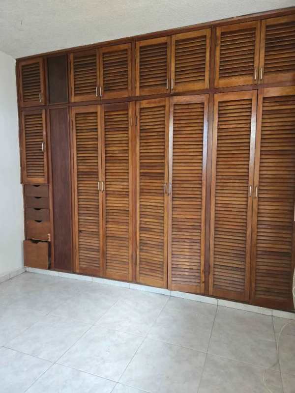 Bedroom with large wooden closet storage space PH La Alameda Villa de las Fuentes Panama