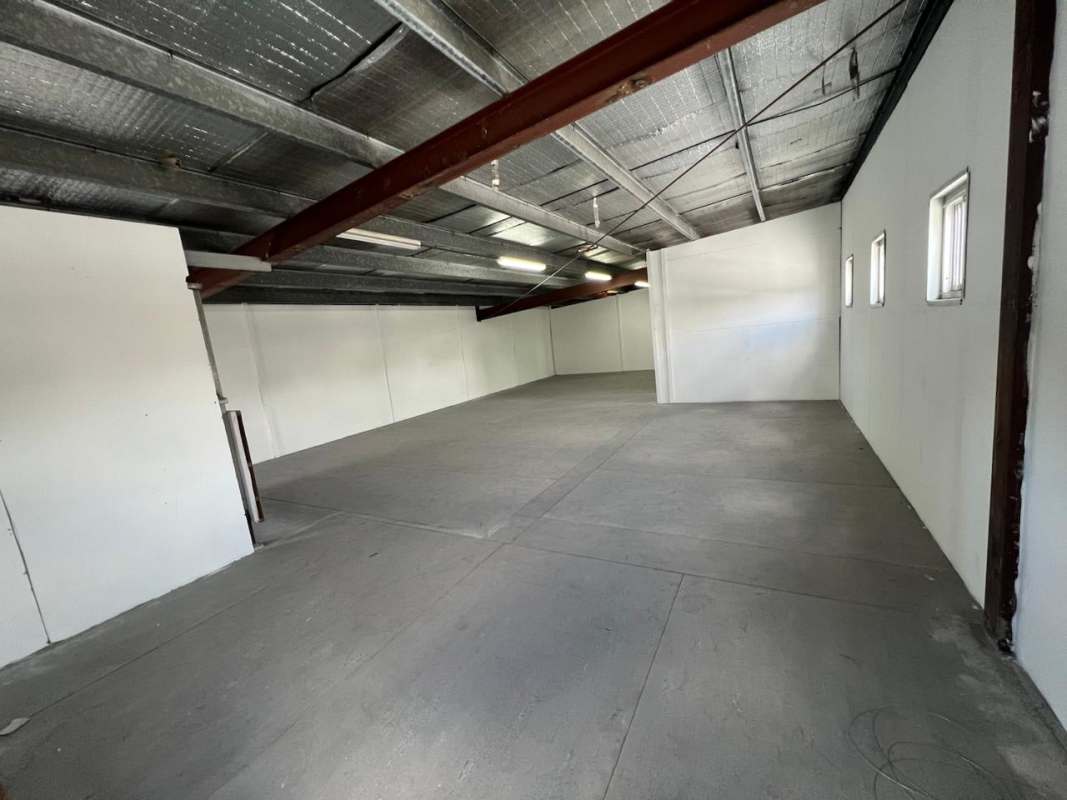 Large warehouse interior second floor with industrial concrete flooring and metal beams in El Ingenio Bethania Panama City