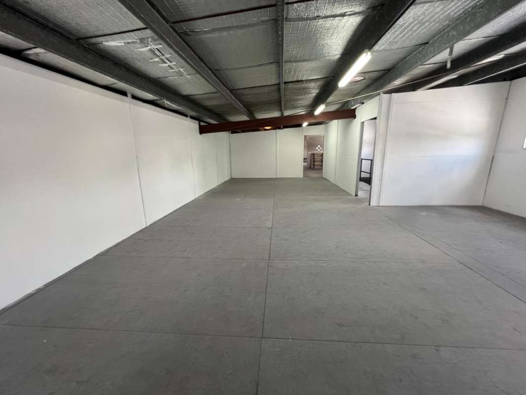 Industrial stairwell with handrails and exposed ceiling leading to warehouse second floor in El Ingenio Bethania Panama