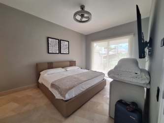 Bright bedroom suite with terrace access and panoramic ocean views at Puntarena Buenaventura Panama