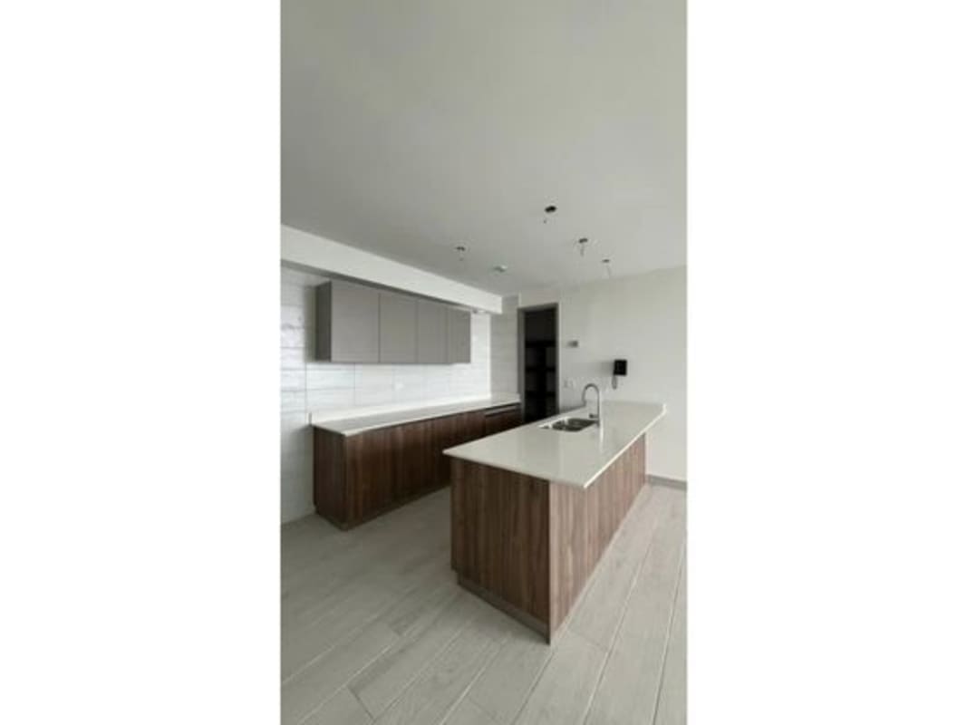Modern kitchen with white quartz countertop island and wood cabinetry in PH Bonavista at The Park Hato Pintado Panama City