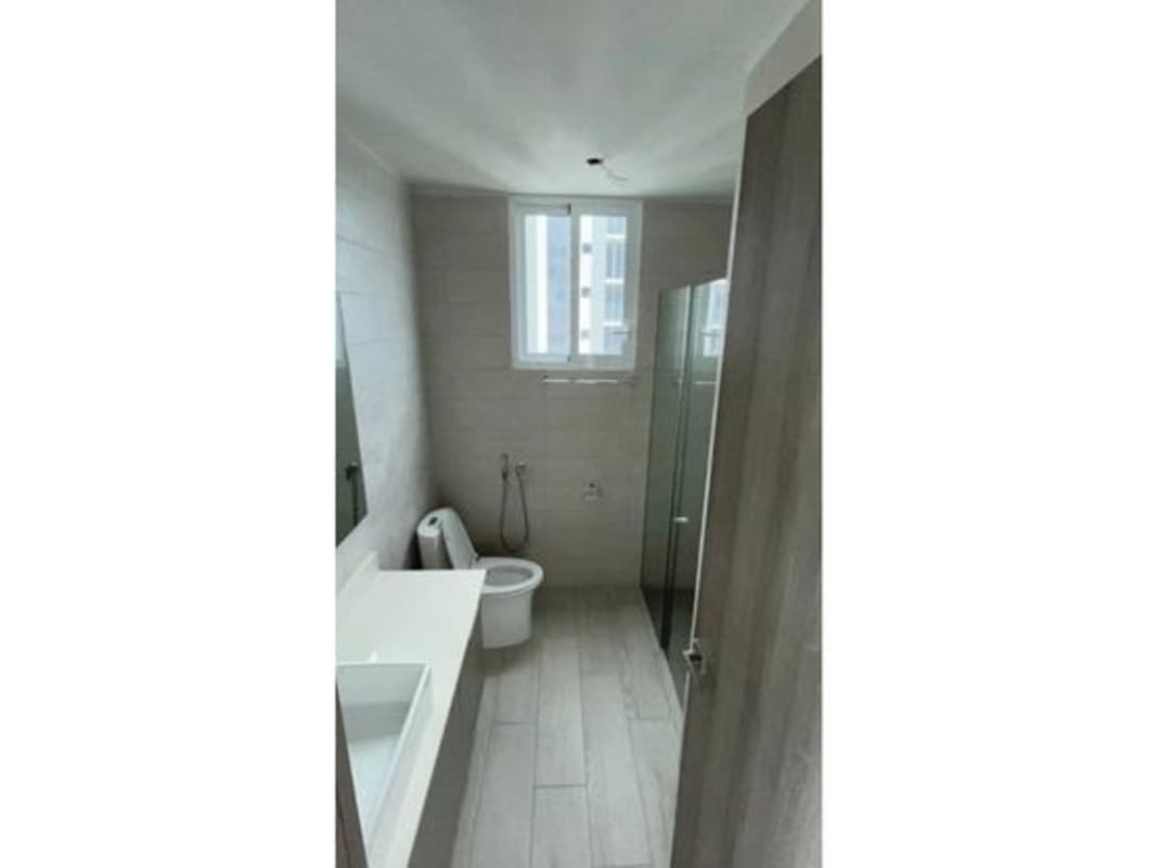 Bright bathroom with glass shower, large mirror, modern vanity in PH Bonavista at The Park Panama City