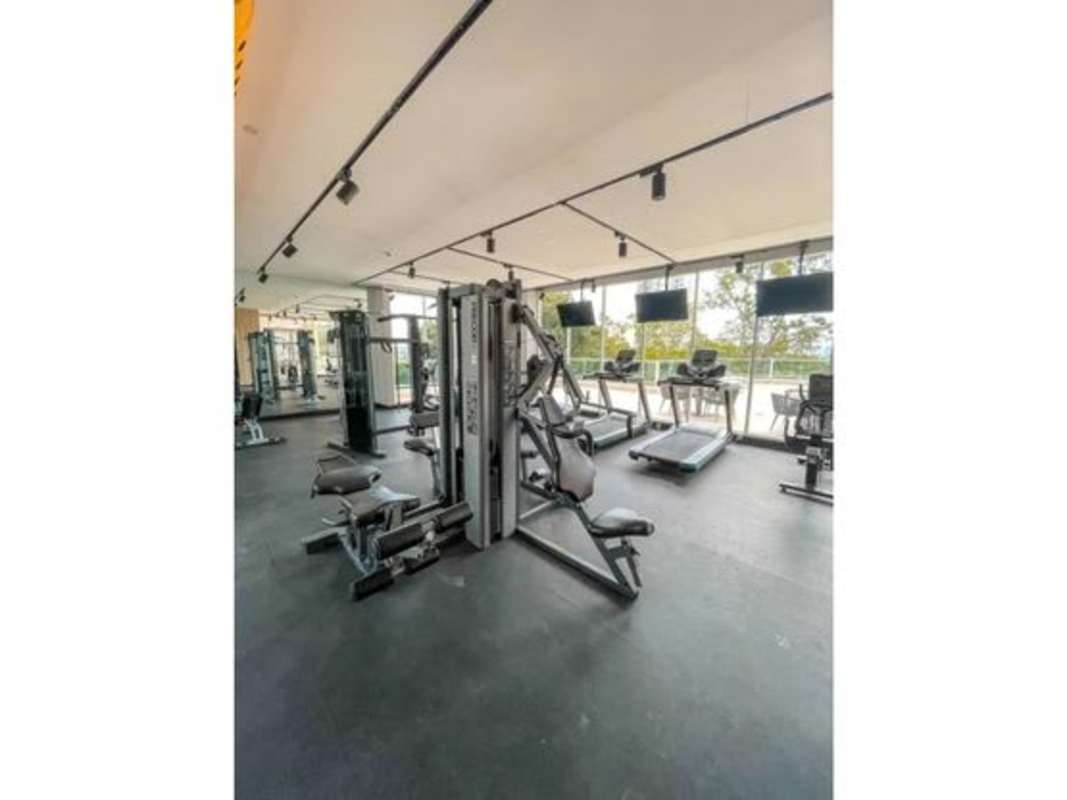 Lobby with glass walls, modular sofas, green wall in PH Bonavista at The Park Panama