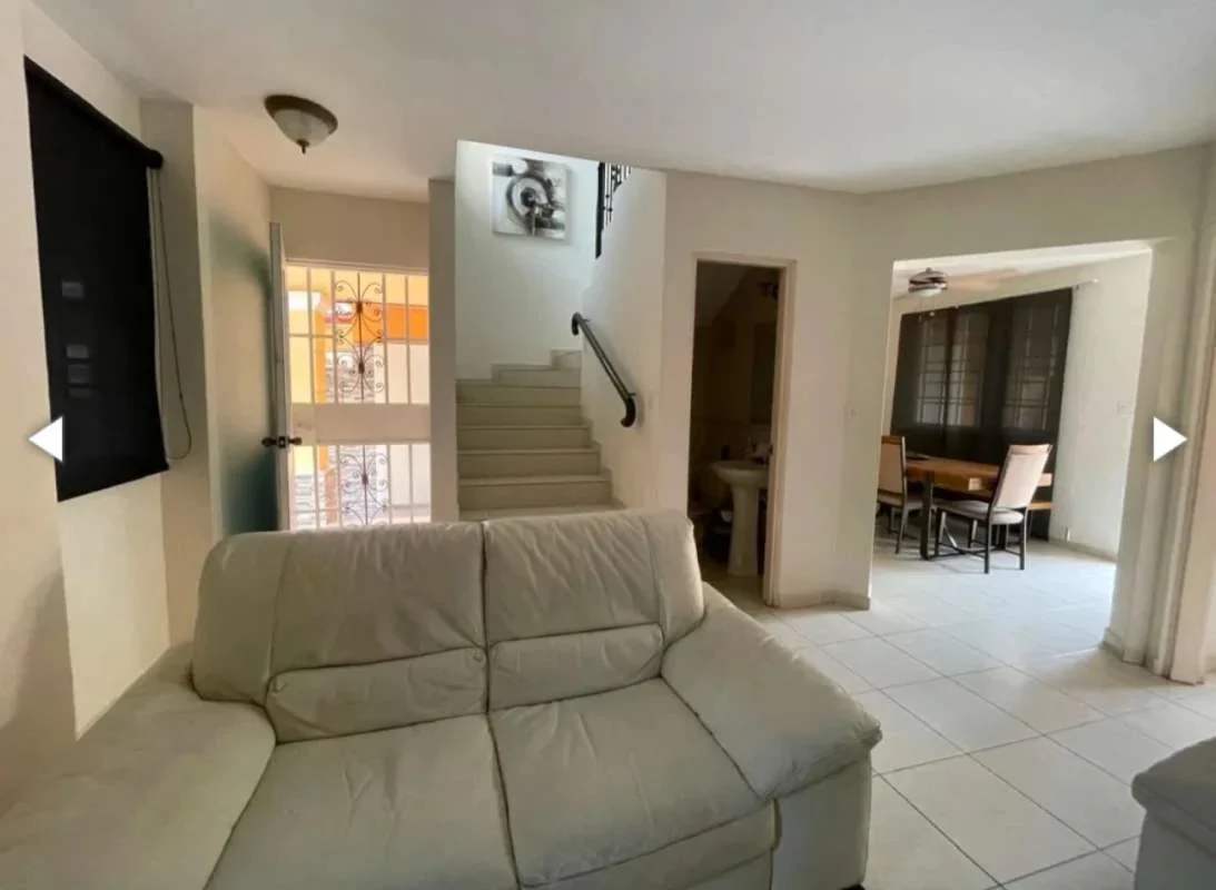 Spacious living dining room with tiled floors and staircase in Villa Lucre house