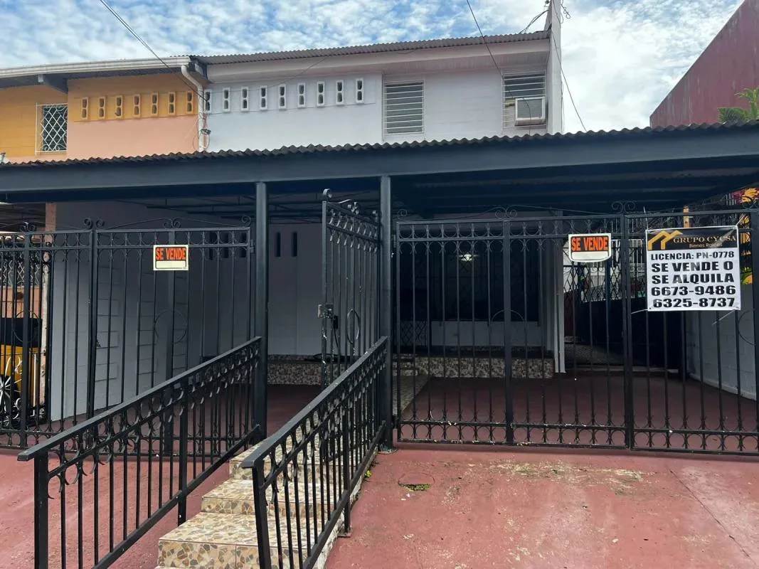 Interior stairwell with white walls, tile floors and black wrought iron railing La Loceria Panama