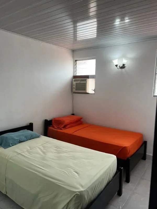 Two-story house exterior with balcony, iron gates and accessible ramp La Loceria Panama