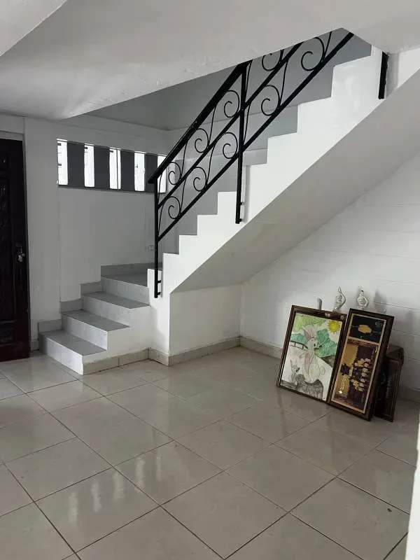 Kitchen with granite countertop wooden cabinets tile backsplash hood La Loceria Panama