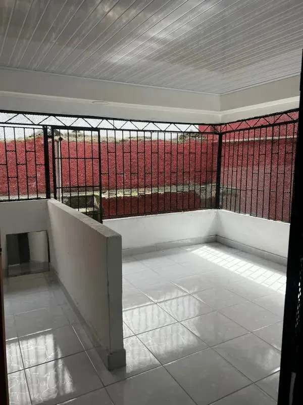 Bright bedroom with double bed, windows, tile floors in La Loceria Panama