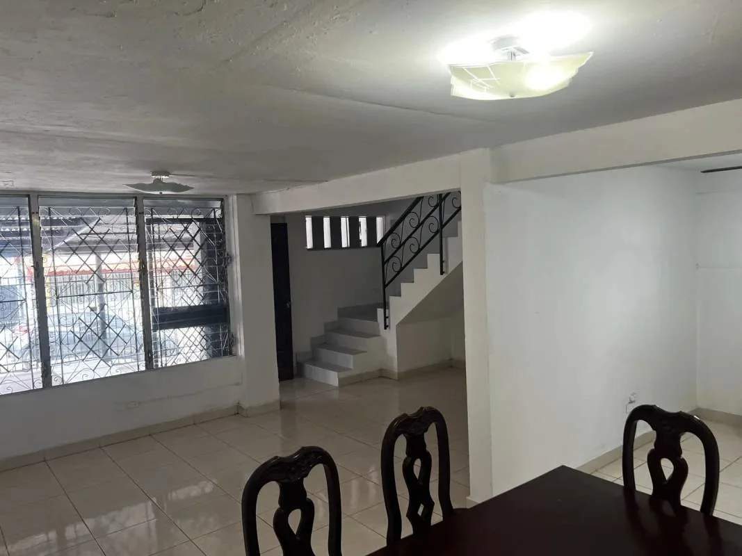 Metal roof carport with iron gate and plants at La Loceria house Panama City