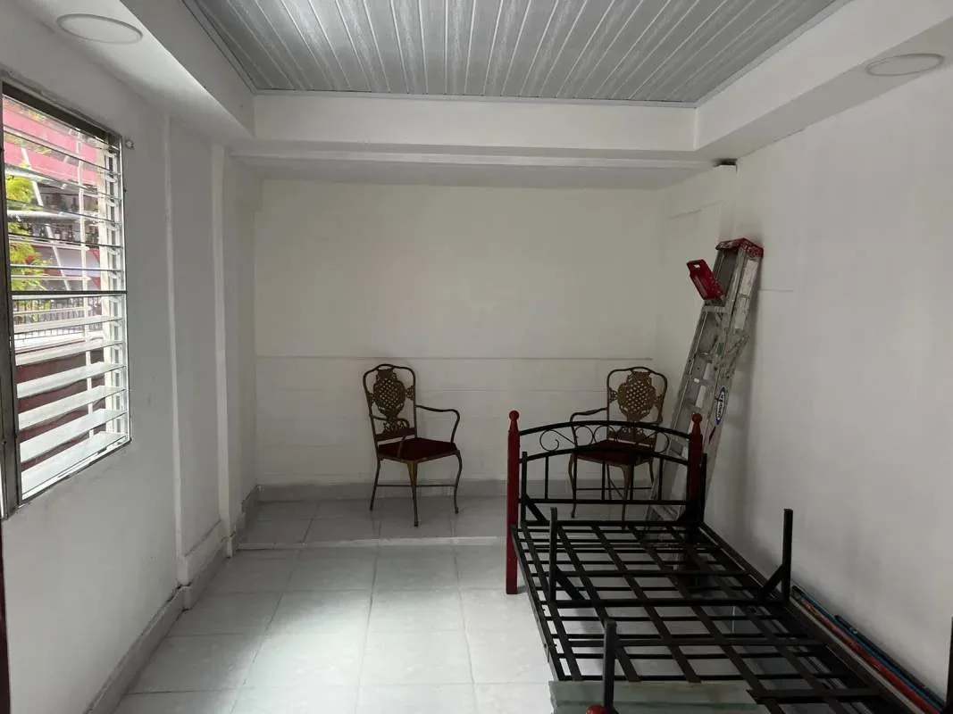 Covered carport gated with metal fence, outdoor plants in La Loceria Panama