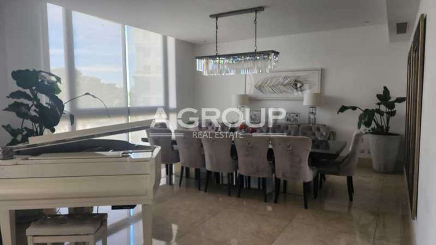Contemporary condo living room with large TV, marble floors, glass coffee table PH Valery Point Panama
