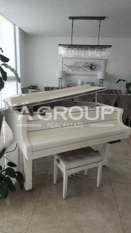 Modern dining room with crystal chandelier, piano, marble floor, large windows PH Valery Point Panama