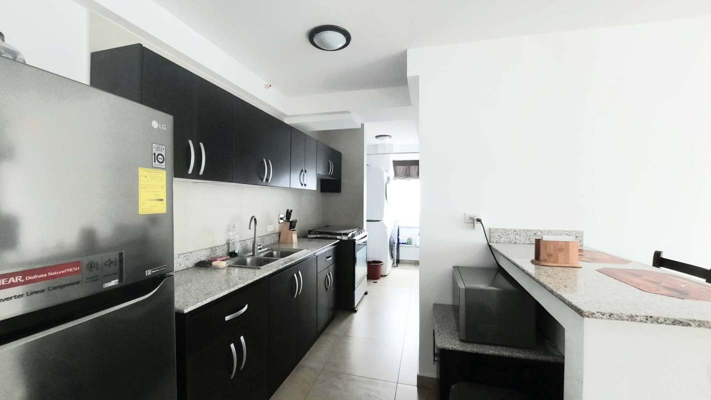 Open concept kitchen with granite countertops and appliances in Vista Park Towers, Panama City