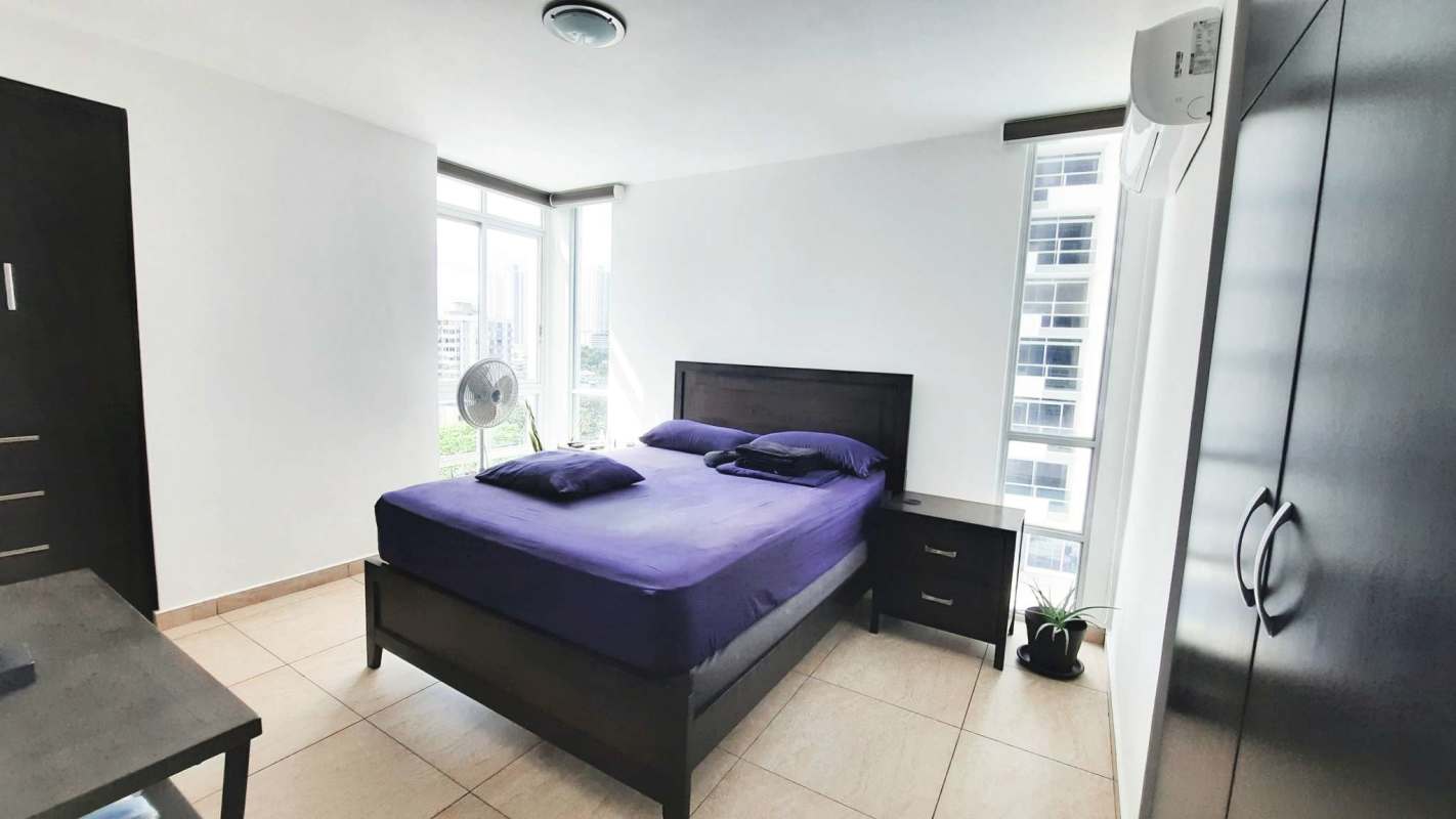 Bright bedroom with purple bedding, city view, AC and closet at PH Vista Park Towers Panama City