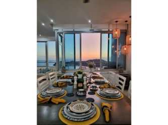 Modern dining room overlooking Pacific Ocean with sunset view at PH Casa Bonita Penthouse Veracruz Panama