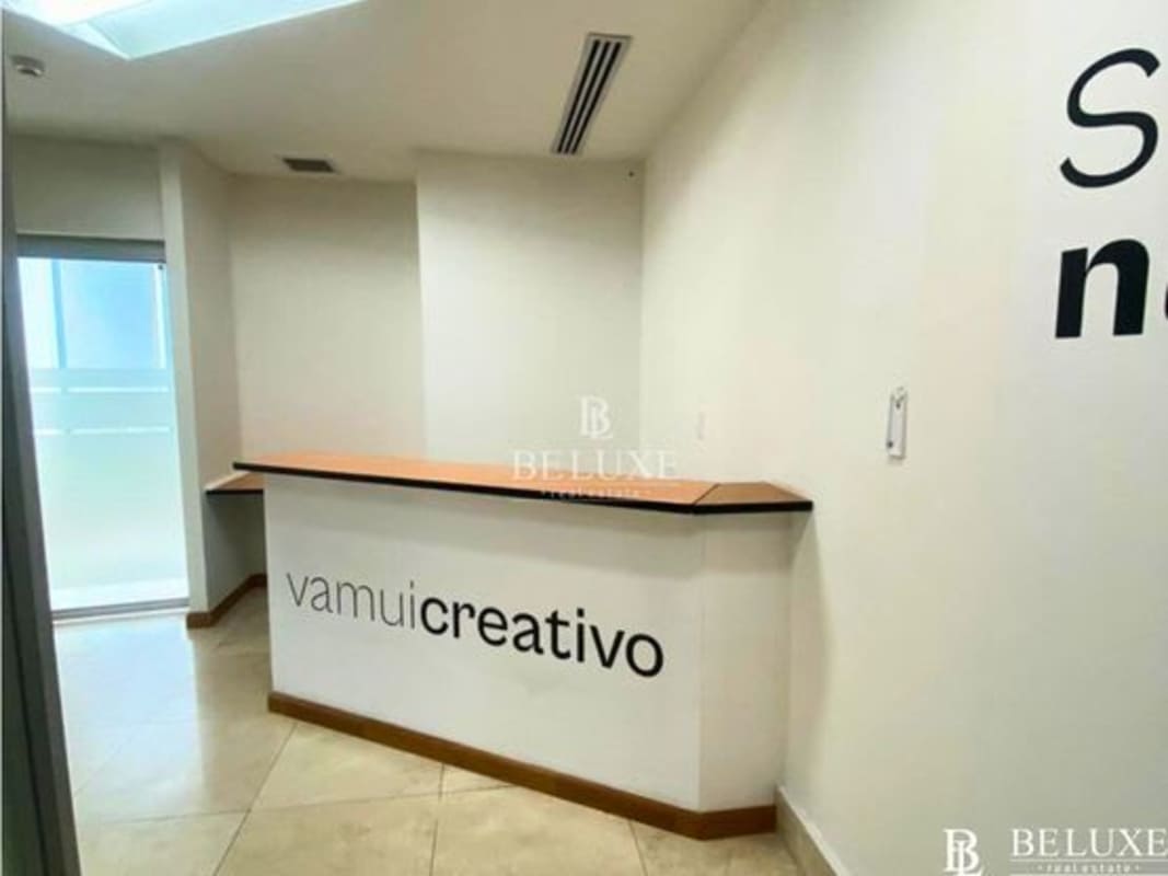 Modern reception area with counter and natural light in leased office F&F Tower Panama