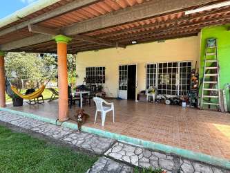 Open plan living and dining with exposed beams and ceiling fans beach house Gorgona Panama