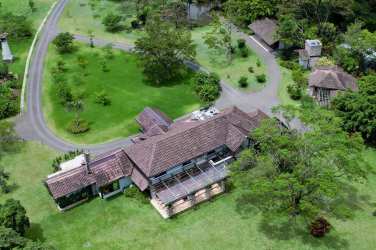 Spacious master bedroom with vaulted wood ceiling, fireplace, and scenic views in El Valle de Antón home