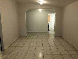 Spacious open tiled living room with arch in Villas del Campo La Chorrera Panama