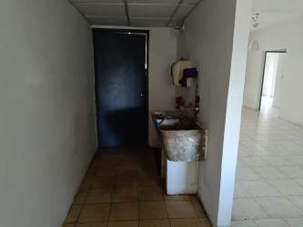 Furnished bedroom with wood bed frame dresser window bars Villas del Campo Panama