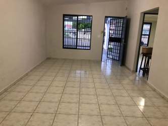 Simple kitchen with tiled backsplash, cabinets and open shelving in Villas del Campo La Chorrera