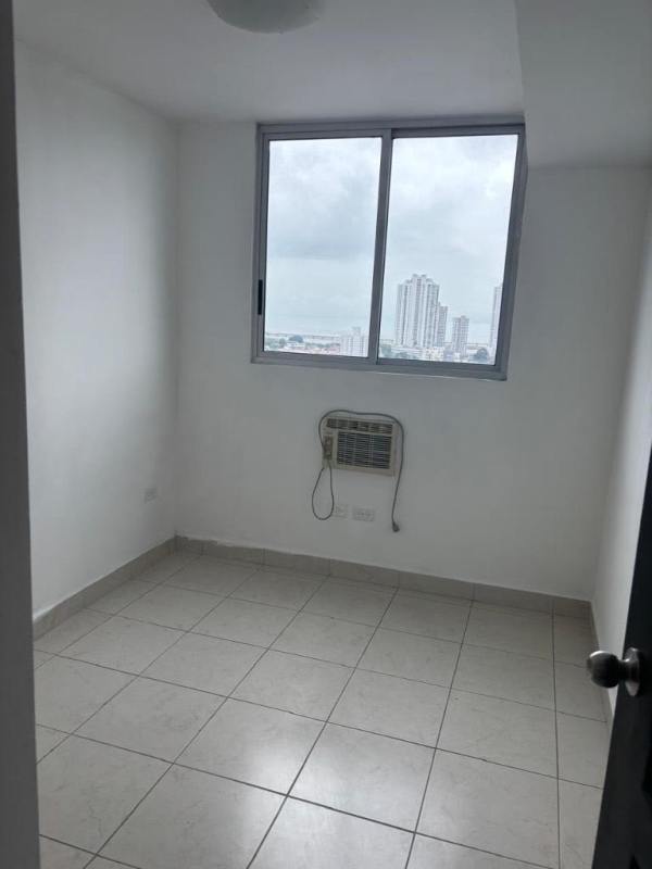 Galley kitchen with granite countertops white cabinets in PH Parque Lefevre Panama