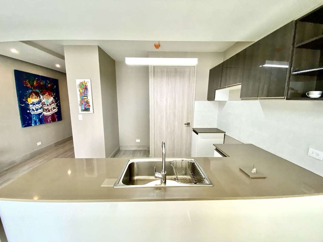 Contemporary kitchen with island sink and sleek cabinetry at PH Azurre, Bella Vista Panama.