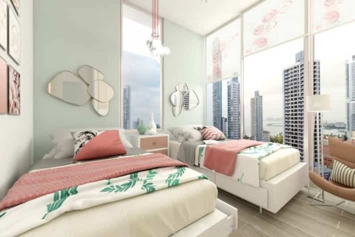 Bright bedroom with large windows overlooking Panama City skyline at PH Azurre.